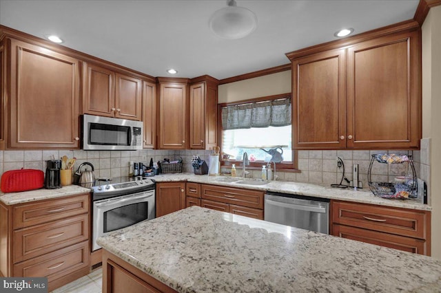 kitchen featuring sink, stainless steel appliances, light stone counters, decorative backsplash, and ornamental molding