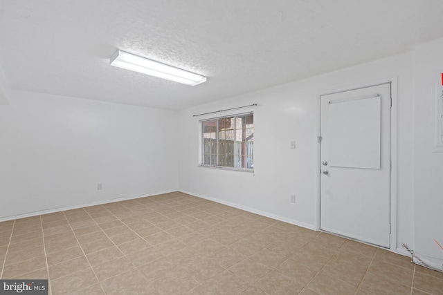 unfurnished room with a textured ceiling