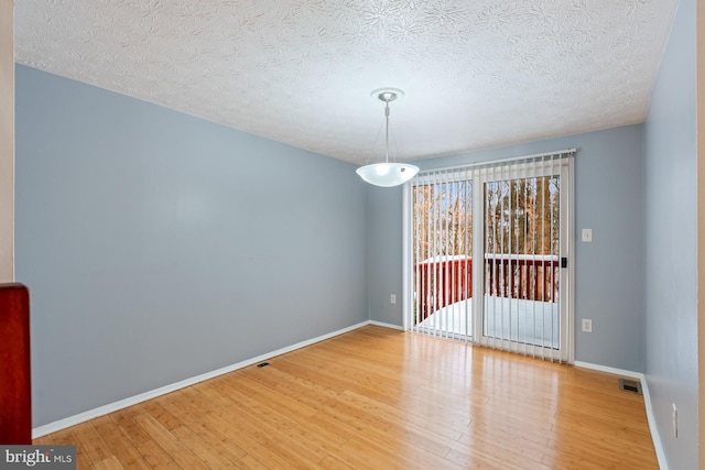 interior space with hardwood / wood-style floors and a textured ceiling