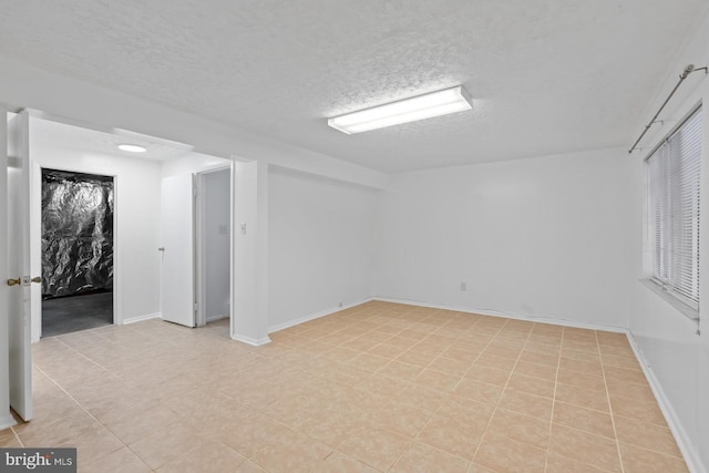 spare room with a textured ceiling