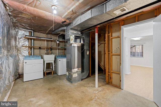 basement featuring washer and dryer and sink