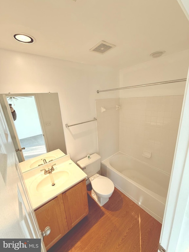 full bathroom with toilet, shower / bathtub combination, hardwood / wood-style floors, and vanity