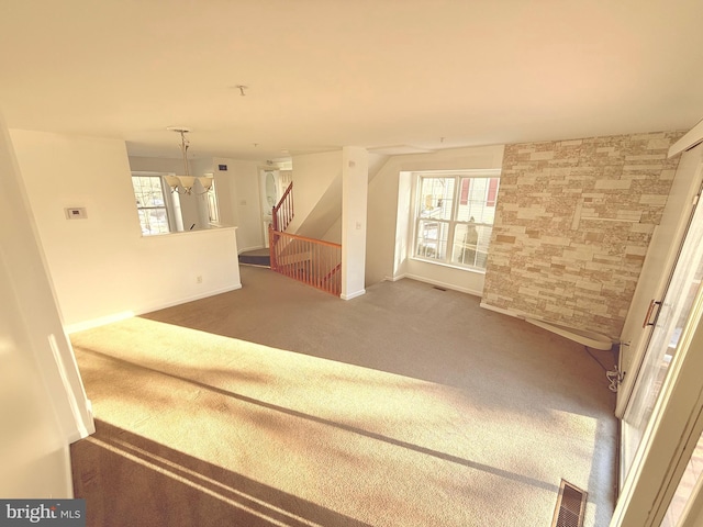 interior space featuring carpet floors and a chandelier