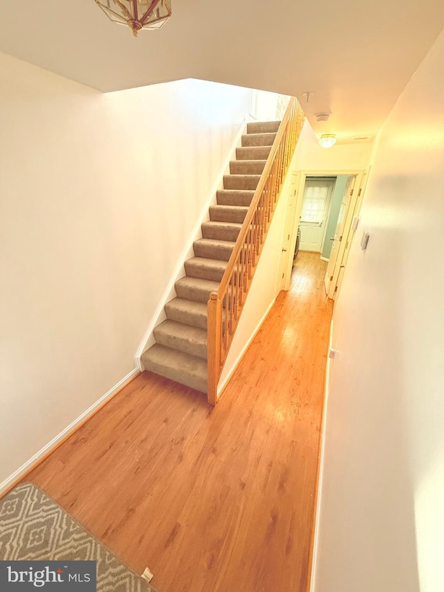 stairs featuring wood-type flooring