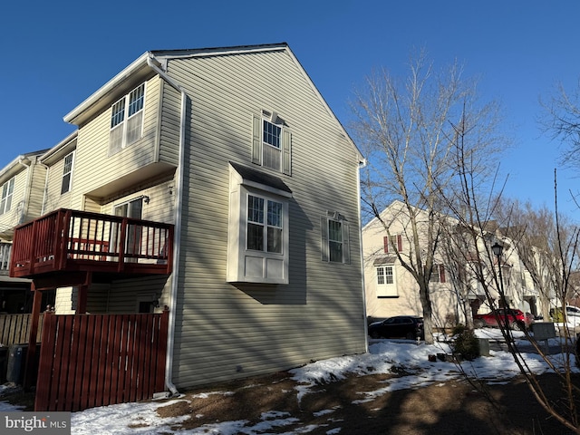 view of snowy exterior with a deck