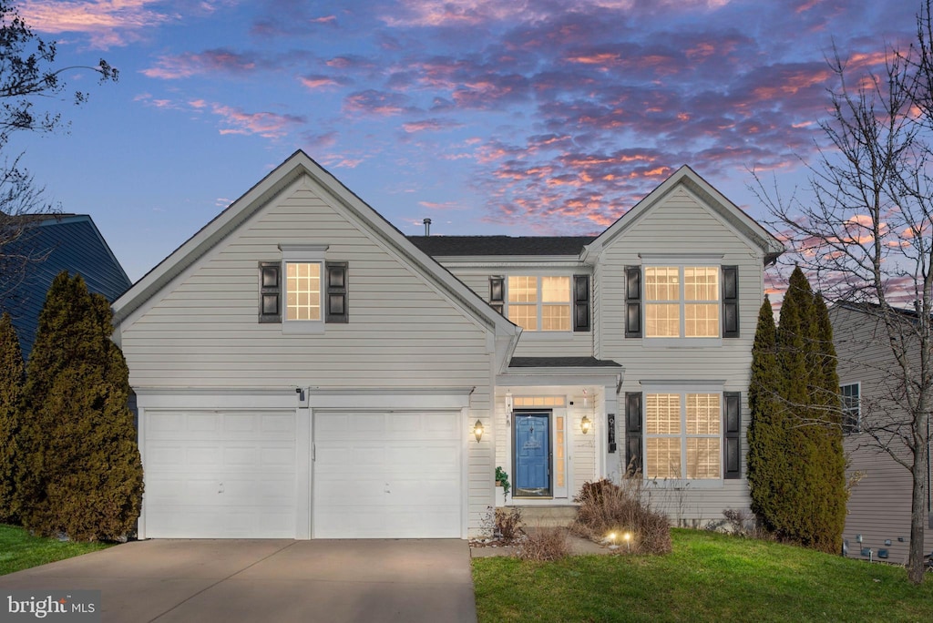 view of property with a garage and a yard