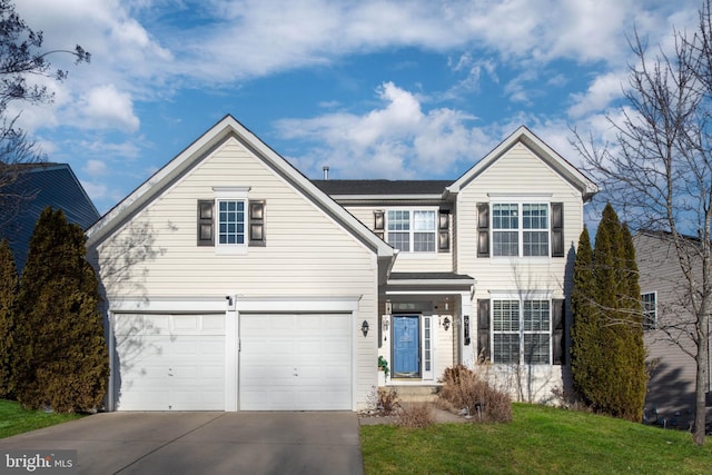 view of property featuring a garage and a front lawn