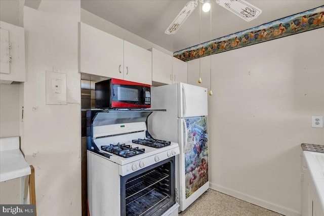 kitchen featuring white appliances, ceiling fan, and white cabinetry