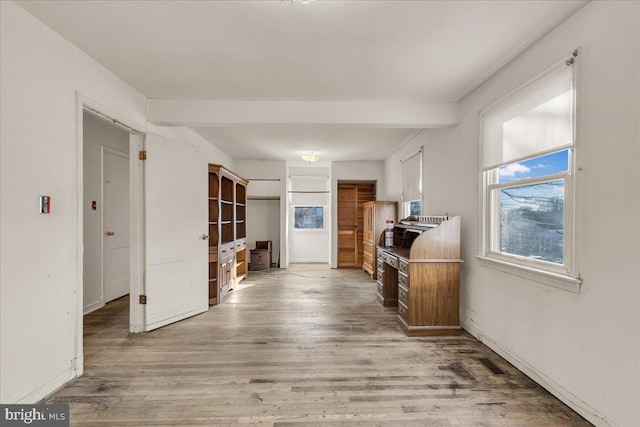 kitchen with beam ceiling and wood-type flooring