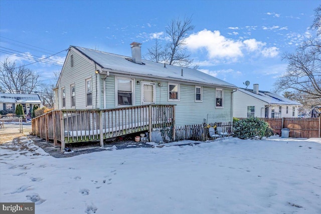 snow covered property with a deck