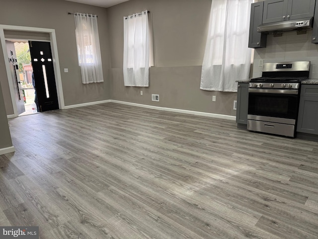 kitchen featuring gray cabinetry, gas stove, and light hardwood / wood-style floors