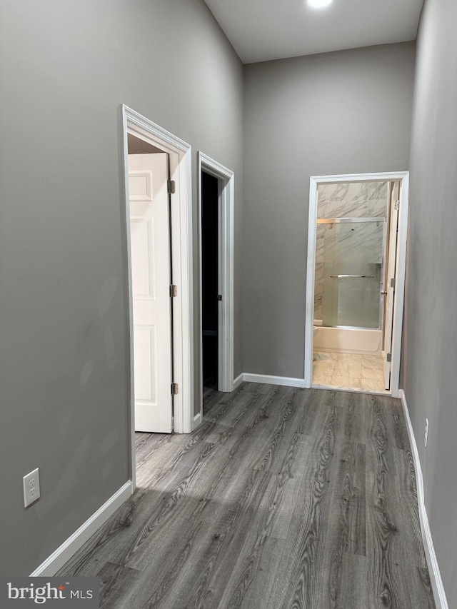 hallway with dark hardwood / wood-style floors