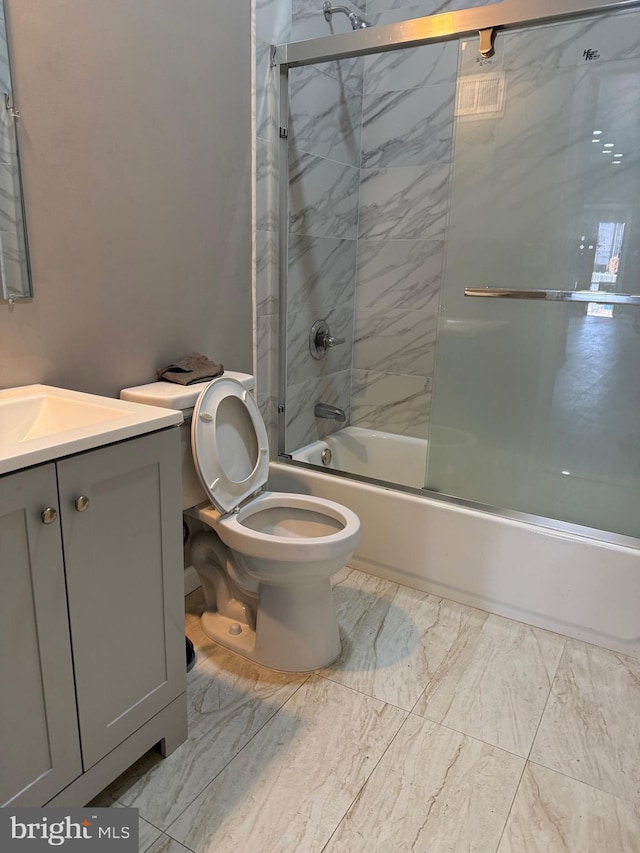 full bathroom with vanity, toilet, and enclosed tub / shower combo