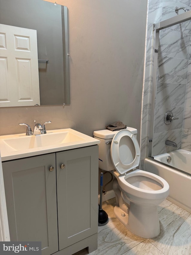 full bathroom with combined bath / shower with glass door, vanity, and toilet