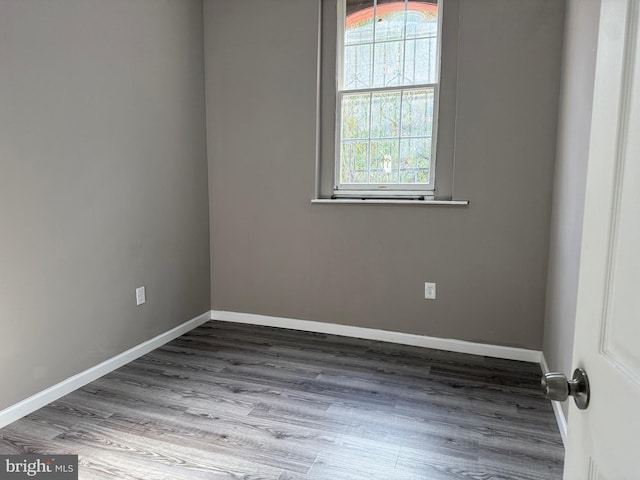 spare room featuring hardwood / wood-style flooring and a healthy amount of sunlight