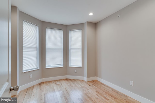 spare room featuring light hardwood / wood-style flooring and a wealth of natural light