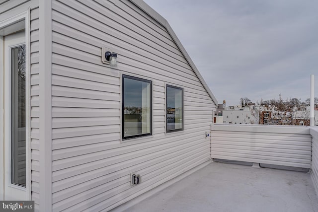 view of side of home featuring a balcony