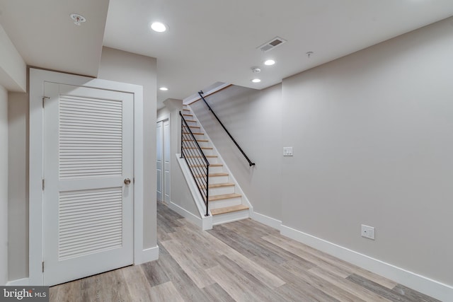 staircase with hardwood / wood-style flooring