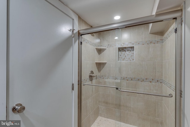 bathroom featuring a shower with shower door