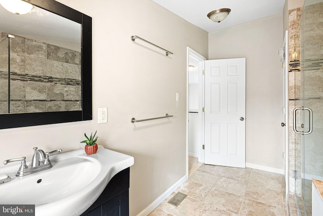 full bath featuring a stall shower, baseboards, visible vents, and a sink