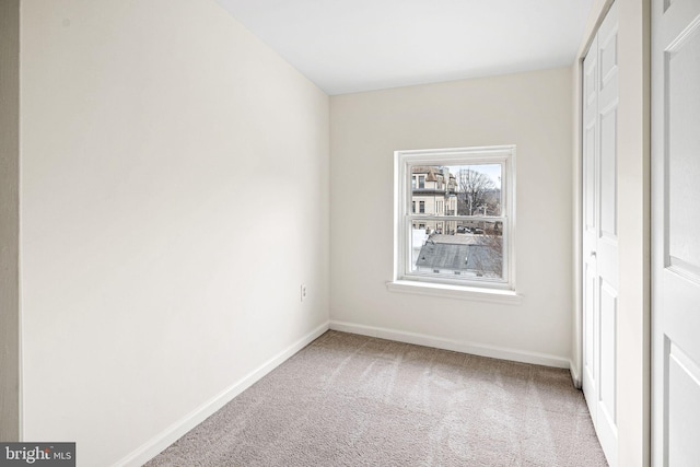 unfurnished bedroom featuring carpet and baseboards