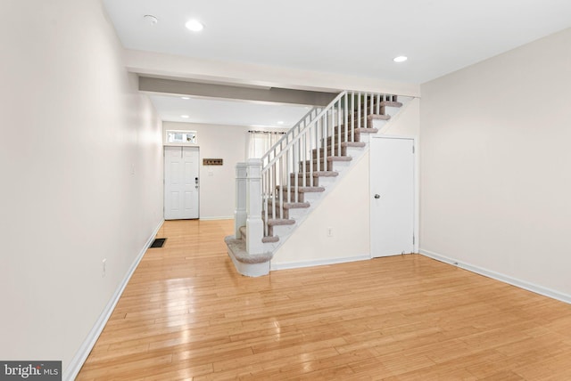 entryway with recessed lighting, visible vents, baseboards, stairs, and light wood-type flooring