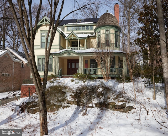 view of front of home with covered porch and a balcony