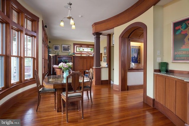 dining room with hardwood / wood-style floors and a notable chandelier