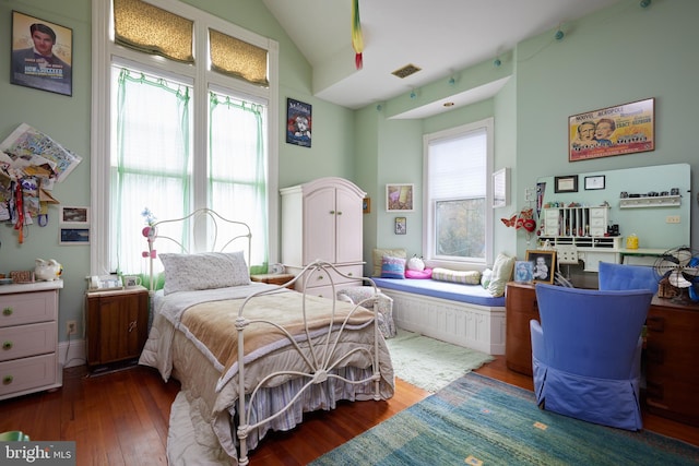 bedroom featuring lofted ceiling and wood-type flooring