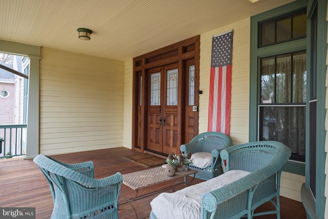 view of exterior entry featuring covered porch