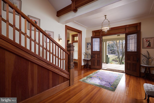 foyer entrance featuring beamed ceiling and light hardwood / wood-style floors