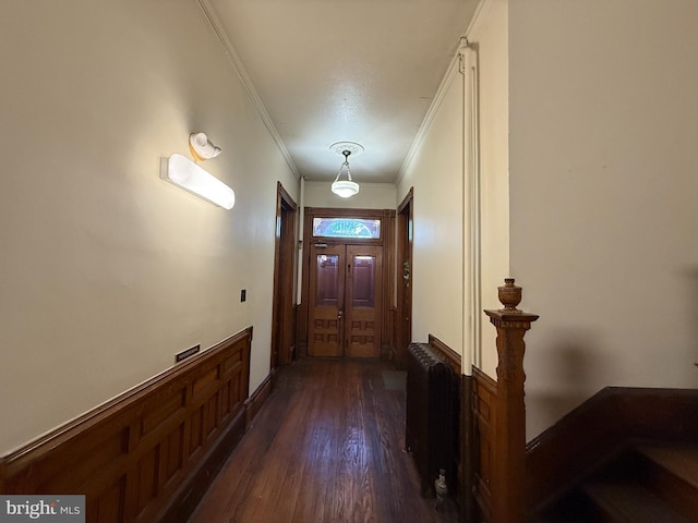 entryway with dark hardwood / wood-style flooring and ornamental molding