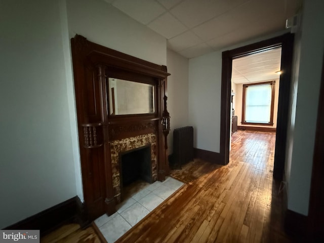 hall featuring light wood-type flooring and radiator heating unit