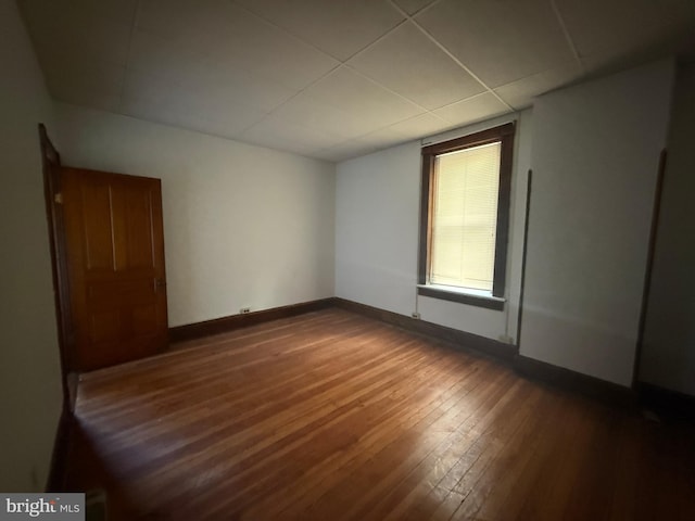 spare room with dark hardwood / wood-style floors