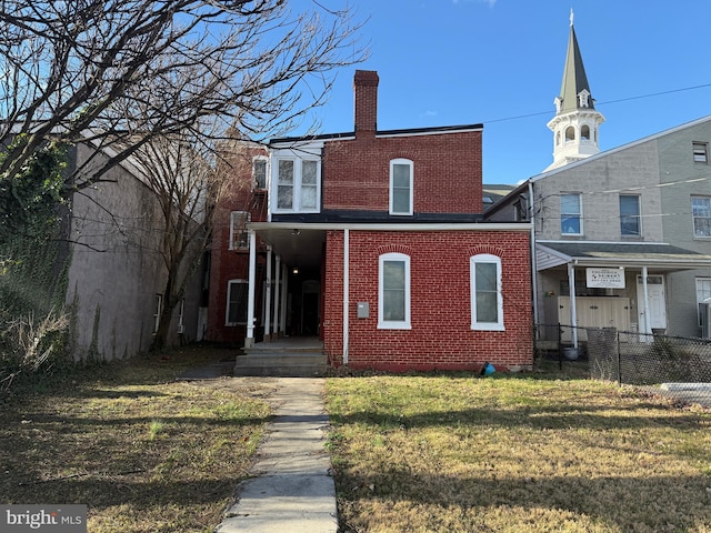 back of house featuring a yard