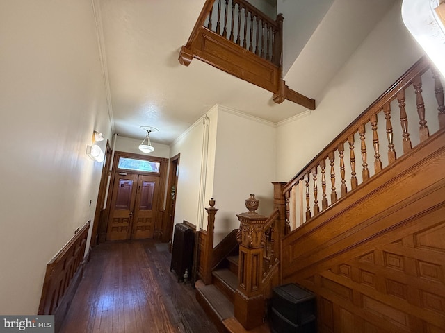 entrance foyer featuring crown molding and dark hardwood / wood-style flooring