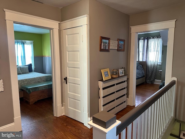 hall with dark hardwood / wood-style floors