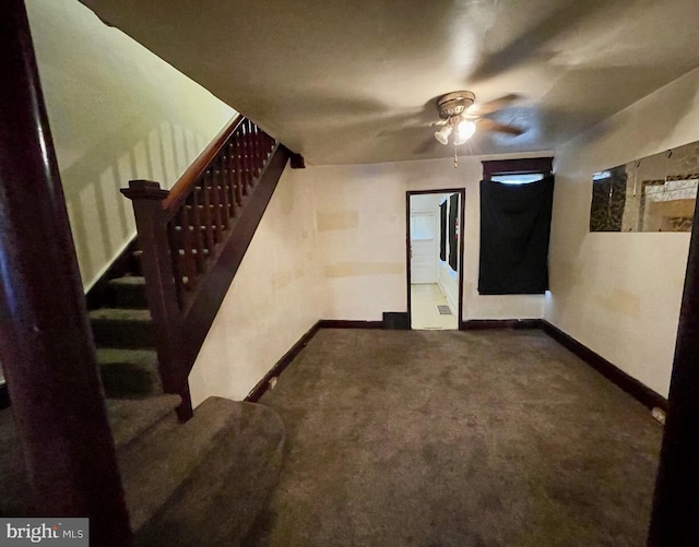 interior space with carpet flooring and ceiling fan