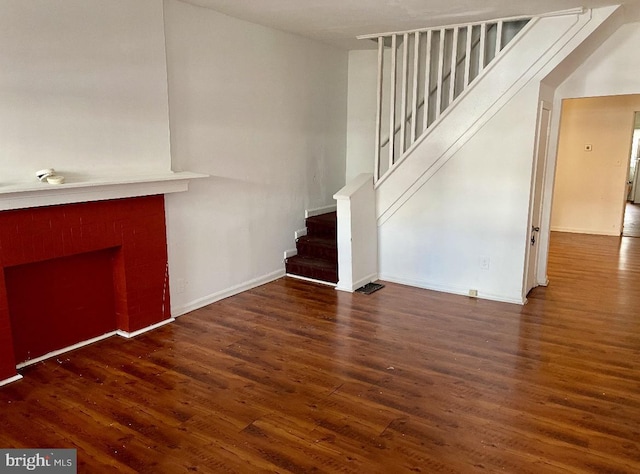 unfurnished living room with dark hardwood / wood-style floors