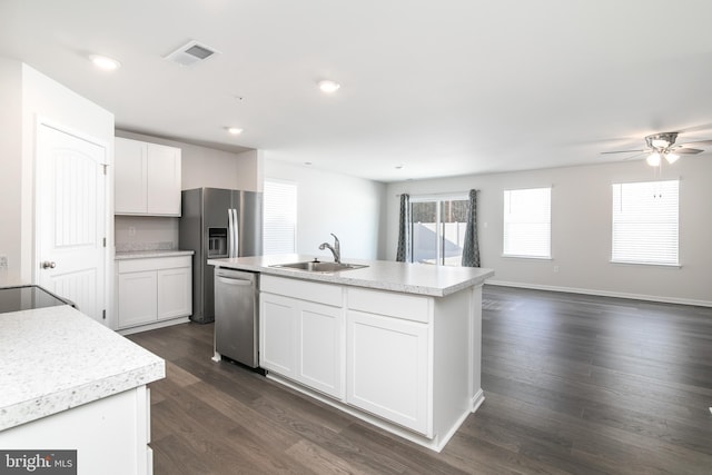 kitchen featuring an island with sink, appliances with stainless steel finishes, white cabinetry, and sink