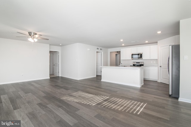 unfurnished living room featuring ceiling fan, dark hardwood / wood-style flooring, and sink