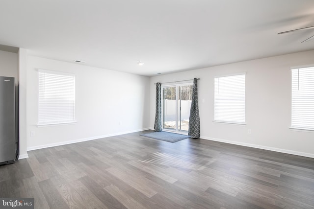 spare room featuring ceiling fan and dark hardwood / wood-style flooring