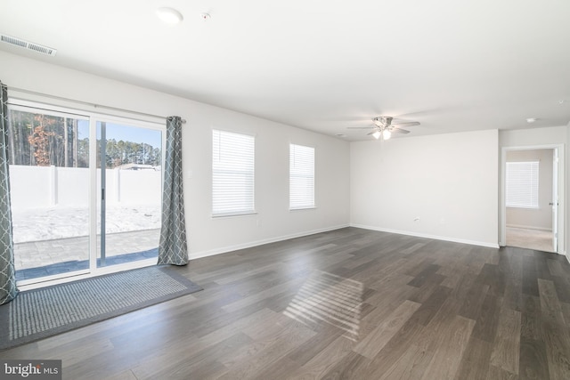 spare room featuring ceiling fan and dark wood-type flooring