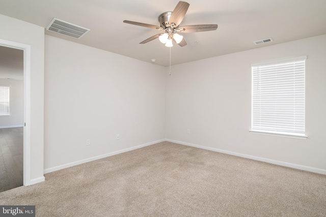 unfurnished room featuring ceiling fan and carpet flooring