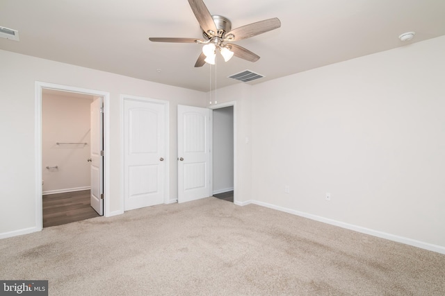 unfurnished bedroom featuring carpet floors and ceiling fan