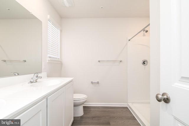 bathroom with vanity, toilet, a shower, and hardwood / wood-style flooring