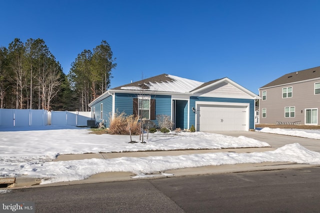 view of front of home with central AC and a garage