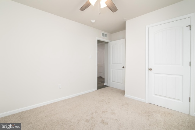 unfurnished bedroom featuring ceiling fan and light carpet