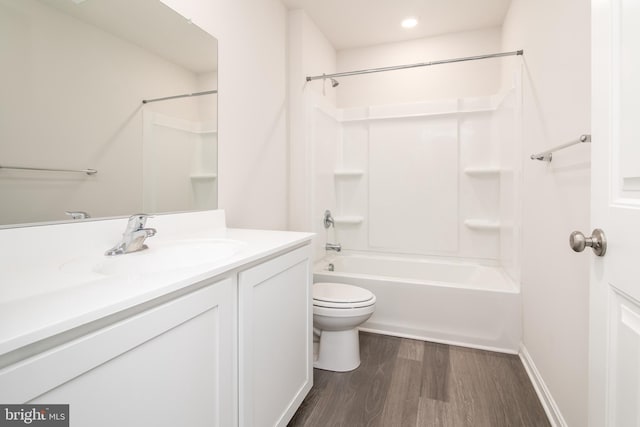 full bathroom featuring shower / bathing tub combination, toilet, vanity, and hardwood / wood-style flooring