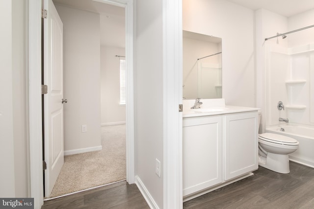 full bathroom with toilet, vanity, hardwood / wood-style floors, and tub / shower combination